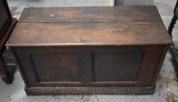 A 17th century oak coffer, with plank top and two panel front, 49 by 94 by 43cm.