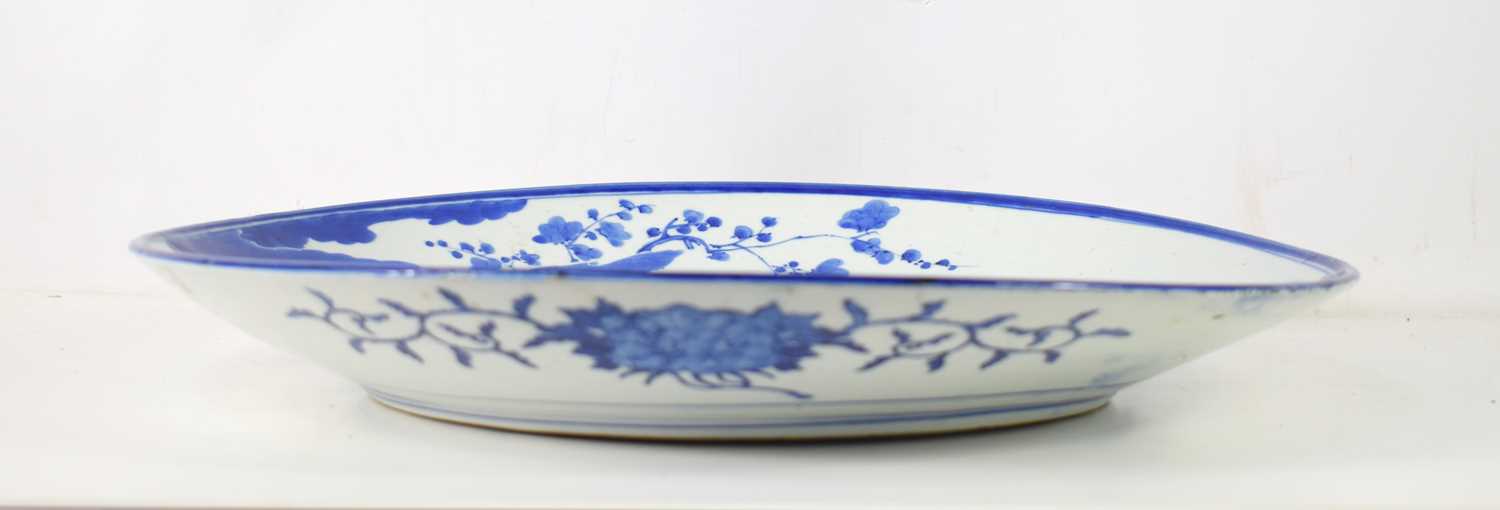 An early 19th century Chinese blue and white porcelain charger, decorated with a peacock amongst - Image 2 of 5