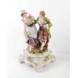A 19th century German porcelain figure group, gentleman with walking cane and lady with pail,