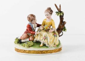 A 20th century Capodimonte figure group of two children in 18th century costume, with oval base,