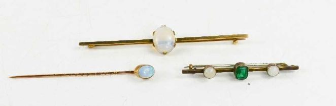 A 9ct gold and opal set bar brooch 7½cm long, the oval opal cabochon 13 by 9mm, 3.73g, a 9ct gold
