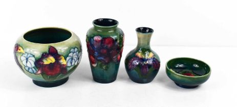 A group of Moorcroft pottery to include two small bud vases, and two bowls, all stamped Moorcroft,