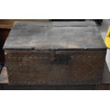 An 18th century oak chest with iron lock plate and twin handles and nulled carving to the front