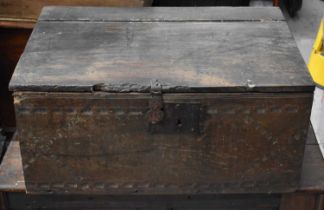 An 18th century oak chest with iron lock plate and twin handles and nulled carving to the front