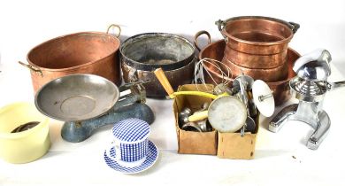 A group of copper wares comprising a two pans with twin handles, and a pot with swing handle,