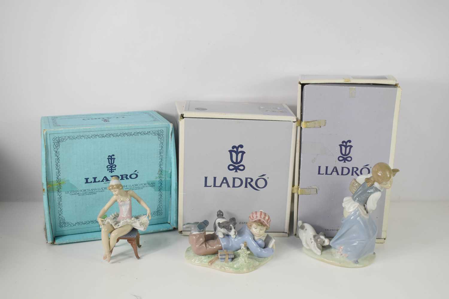 Three porcelain Lladro figurines; Study Buddies, Ballet Dancer, Girl with Puppy, all with the