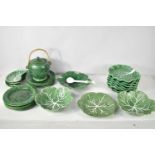 A group of various vine leaf and cabbage ware plates and dishes, including eleven vine leaf