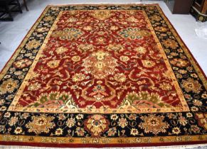 A 20th century Chinese hand woven wool rug retailed by Oriental Rug Gallery, the central red