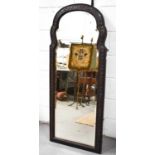 A Victorian large wall mirror, of curved and shaped arch form, the finely carved hardwood frame with