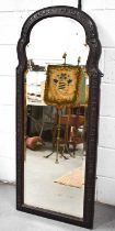 A Victorian large wall mirror, of curved and shaped arch form, the finely carved hardwood frame with