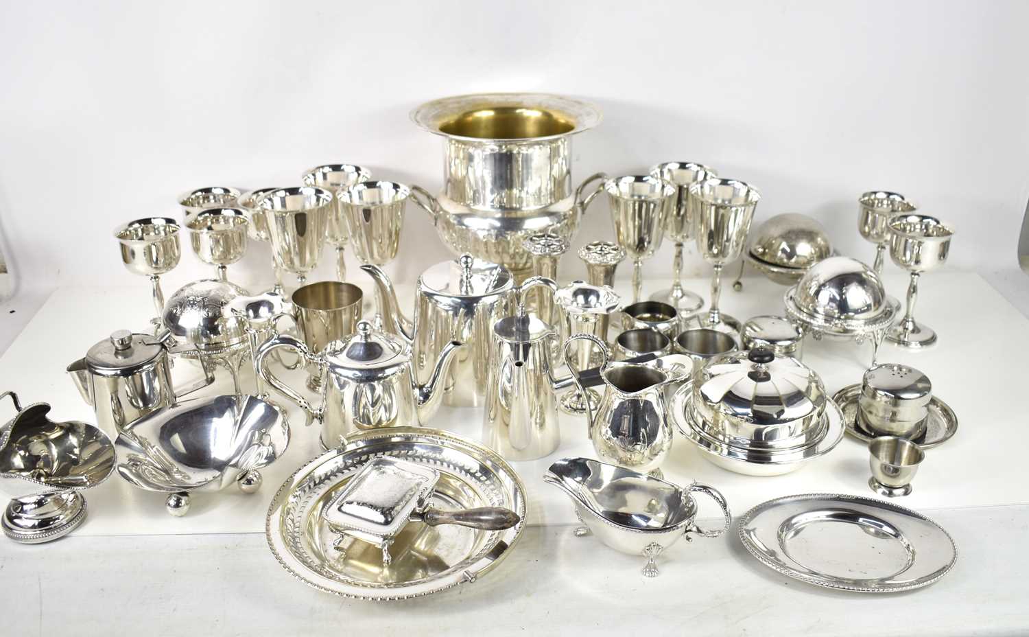 A large collection of silver plate including a chocolate pot, set of six goblets and six smaller