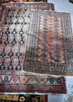 A finely knotted wool rug the terracotta ground with geometric motifs, 150cm by 92cm and another