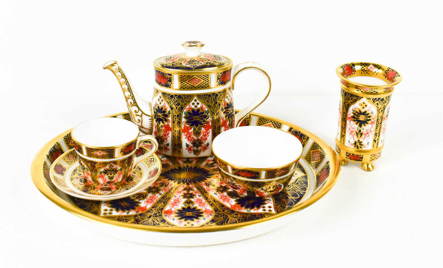 A Royal Crown Derby miniature tea service, comprising tea pot, cup & saucer and sugar bowl, together