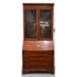A Edwardian mahogany bureau bookcase with interior shelves, the drop down front housing fitted