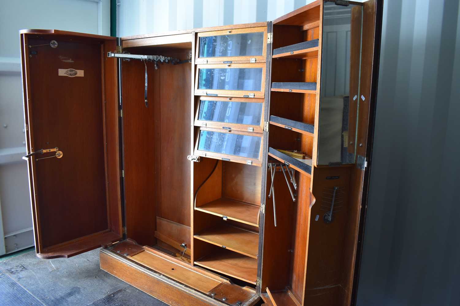 A vintage gentlemans Compactom oak wardrobe, the deep doors opening to reveal a fitted interior with