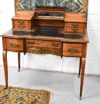An Edwardian lady's writing desk, with twin galleried top, mirror backed and with hinged marquetry
