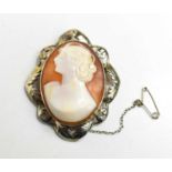 A silver framed cameo, the figure modelled in the modernist style, looking left.