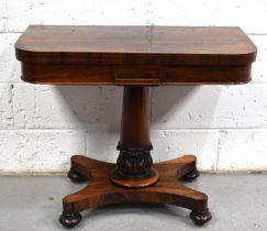 A 19th century rosewood card table with folding and rotating top, the lid opens to reveal a baise