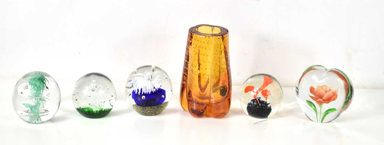 A Whitefriars style amber glass lobed vase together with a group of glass paperweights.