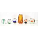 A Whitefriars style amber glass lobed vase together with a group of glass paperweights.