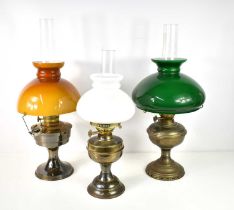 A group of three paraffin lamps, the largest with a green glass shade, and Duplex mechanism, 58cm