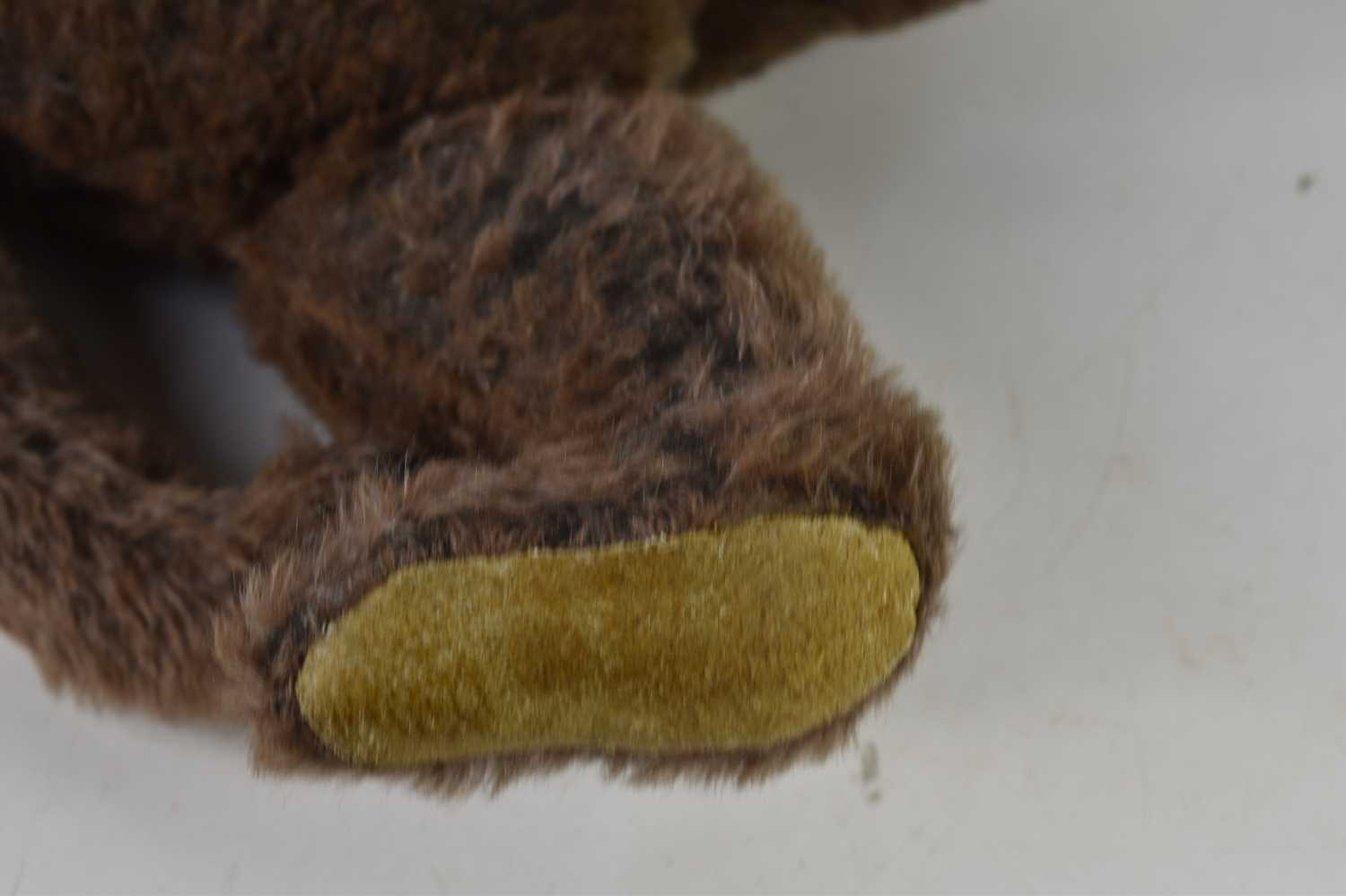 A straw filled teddy bear, in the style of Steiff, brown mohair body, swivel head and jointed at - Image 4 of 6