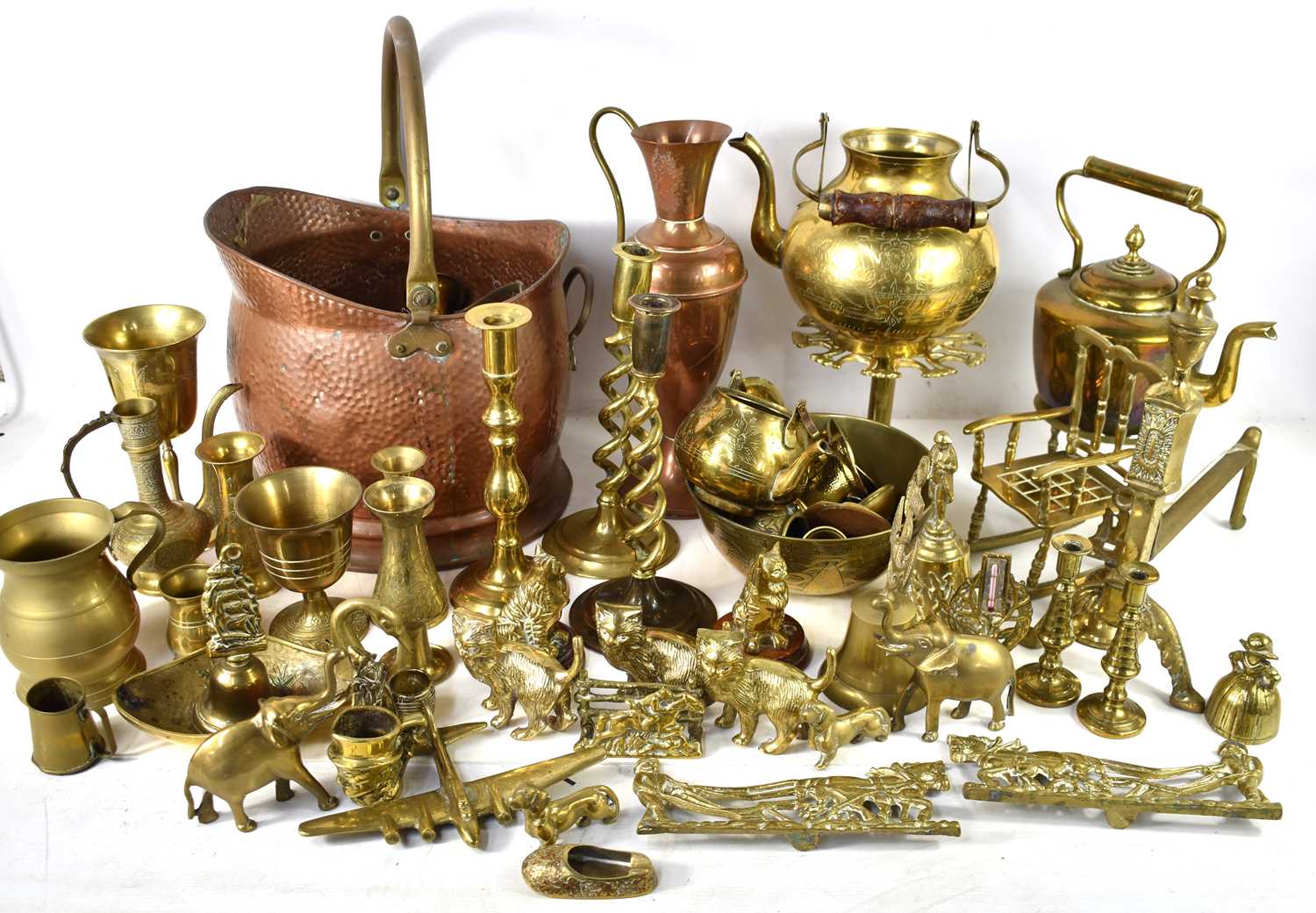 A large group of brass and copper ware to include candlesticks, vase, copper coal bucket, kettle,