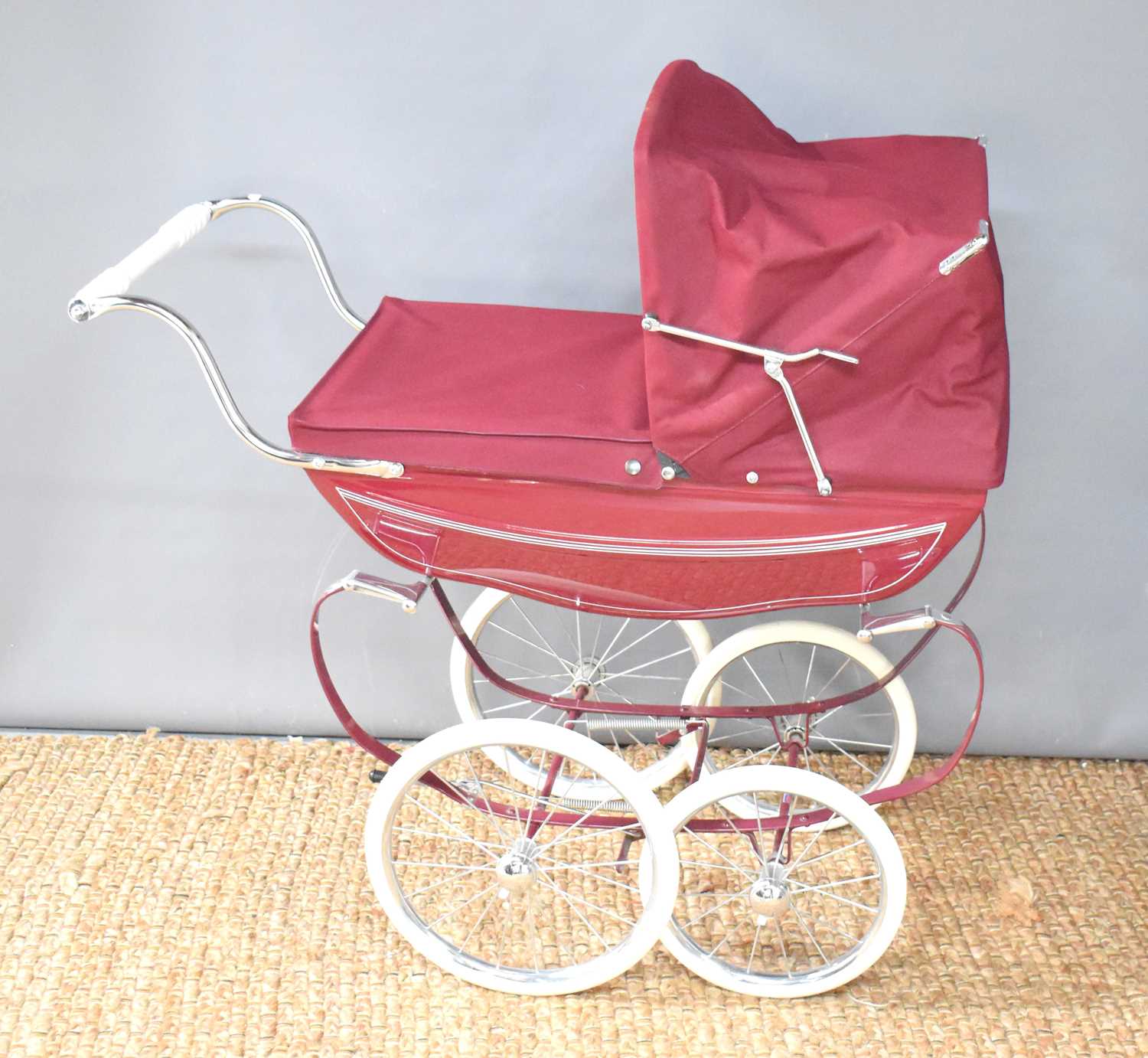 A child's Silvercross coachbuilt pram with canopy.