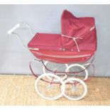 A child's Silvercross coachbuilt pram with canopy.