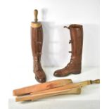 A pair of brown leather riding boots made by Sparkes-Hall of London, complete with wooden trees.