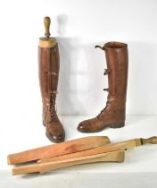 A pair of brown leather riding boots made by Sparkes-Hall of London, complete with wooden trees.