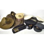 A group of military caps and hats to include a US Air Force officers cap, Naval officers cap, RAF
