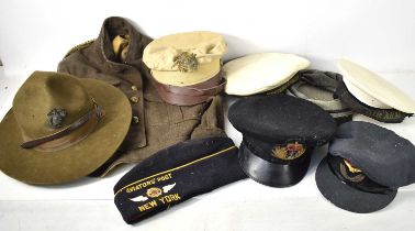 A group of military caps and hats to include a US Air Force officers cap, Naval officers cap, RAF