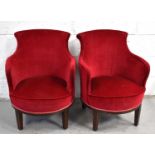 A pair of Art Deco tub chairs upholstered in red velvet.