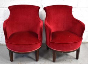 A pair of Art Deco tub chairs upholstered in red velvet.