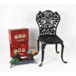 A cast iron childs chair, together with a vintage cast iron comical toy, and two vintage OXO cube