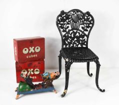 A cast iron childs chair, together with a vintage cast iron comical toy, and two vintage OXO cube