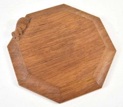 A Robert "Mouseman" Thompson octagonal oak cheeseboard with carved mouse edge, 18.5cm by 18.5cm