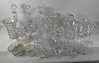 A large collection of cut glass, including three decanters, Stuart Crystal jug, a Webb Corbett vase,