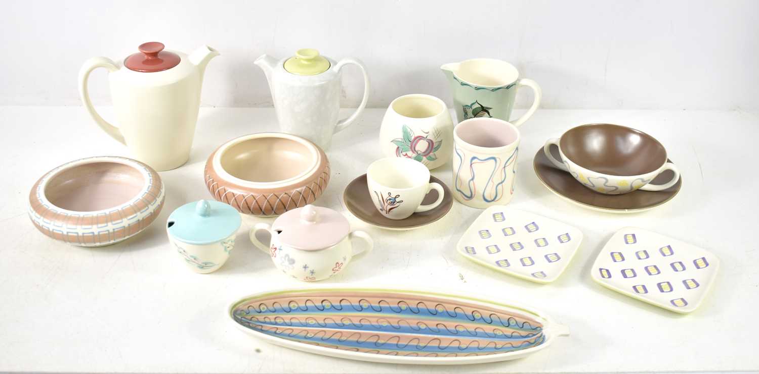 A group of Mid-Century Poole pottery to include a freeform cucumber dish, a mug in the Constellation