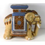 A porcelain conservatory stool/jardiniere stand in the form of a ceremonial Elephant, 45cm high.