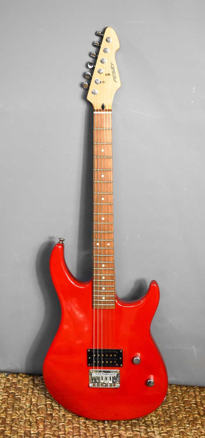 A Peavey Raptor Junior Electric Guitar in red.