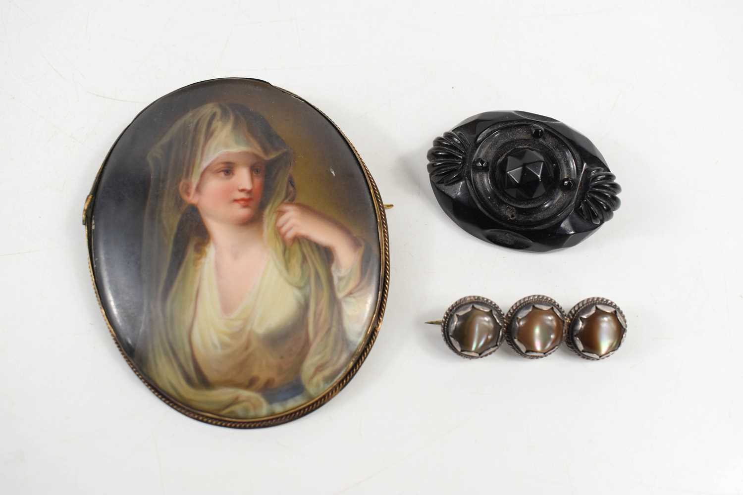 A 19th century miniature portrait brooch / pendant, likely French, the porcelain plaque hand painted