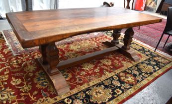 A solid oak 17th century style trestle table, the reclaimed cleated planked top above double