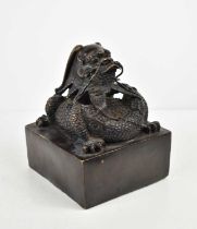 A Chinese 20th century bronze seal, of large proportions, , modelled with a coiled dragon