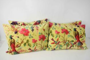 A group of four throw cushions, each with mustard velour ground decorated with pheasants and