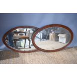 A mahogany wall mirror, the frame with boxwood and barber's pole stringing, with bevelled glass,