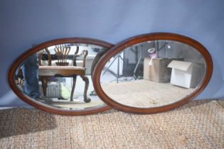 A mahogany wall mirror, the frame with boxwood and barber's pole stringing, with bevelled glass,