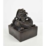 A Chinese 20th century bronze seal, of large proportions, , modelled with a coiled dragon