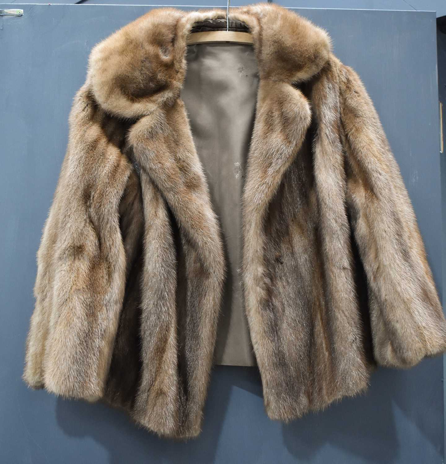 A vintage fur jacket, likely musquash, with brown satin lining.